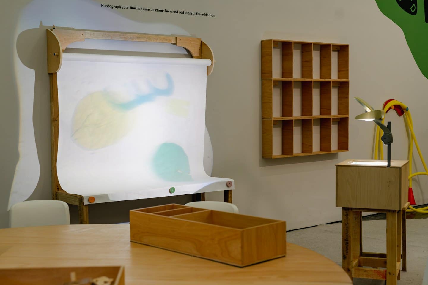 A creative workspace featuring a white board and wooden furniture.